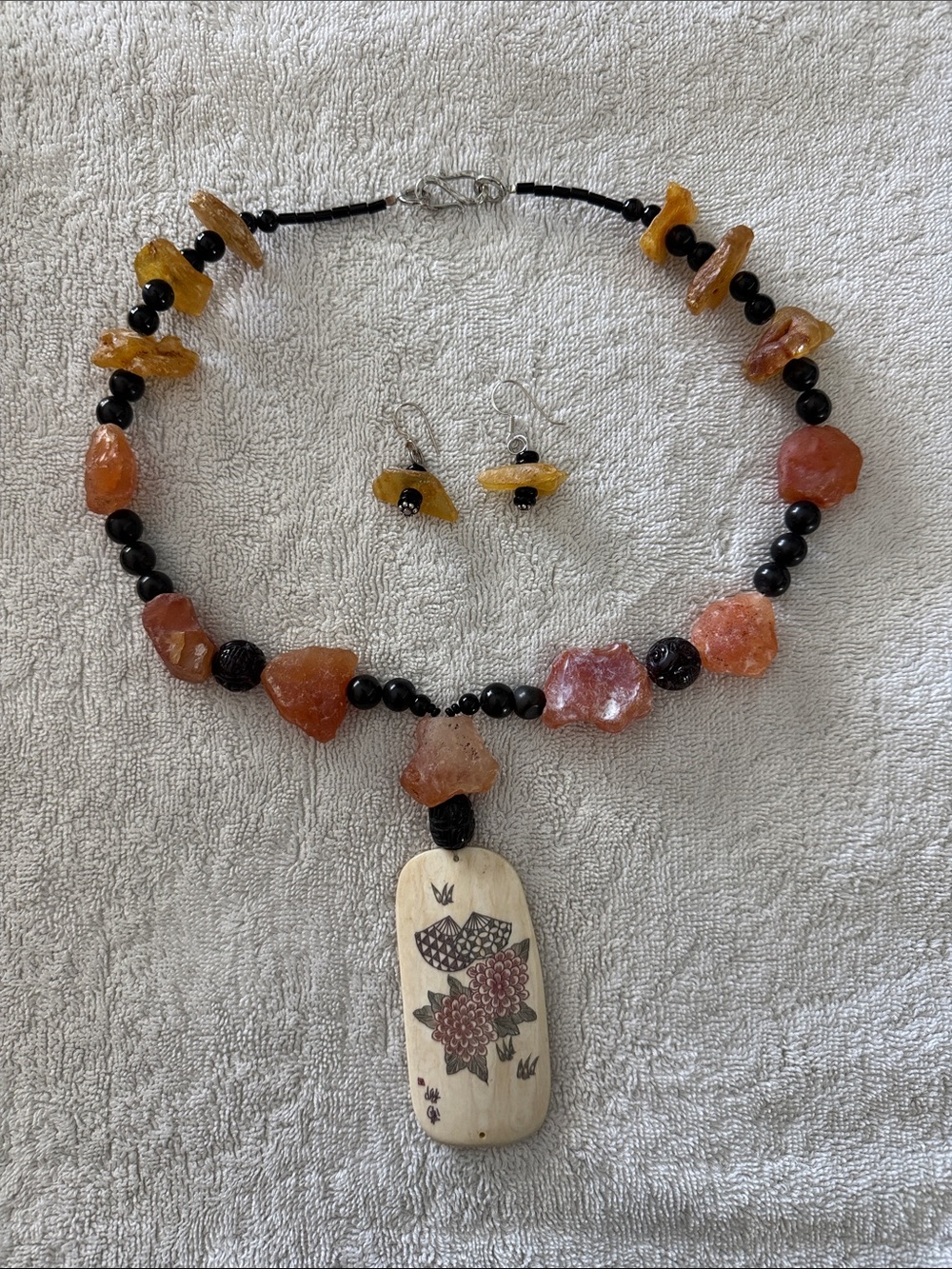 Amber Chip and Black Bead Necklace with Carved Cream Pendant